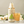 Load image into Gallery viewer, Open bottle of 1 litre Apple Juice alongside a Folkington&#39;s glass of apple juice on a counter. There is a bunch of white roses and green leaves laying in the background behind the bottle and glass.
